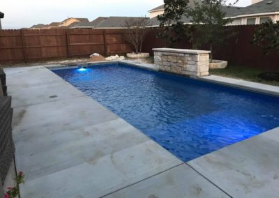 Reflection 31â€™ with Splash Deck (31â€™ x 12â€™ 5â€) is in Sapphire Blue finish with water feature wall before spray deck